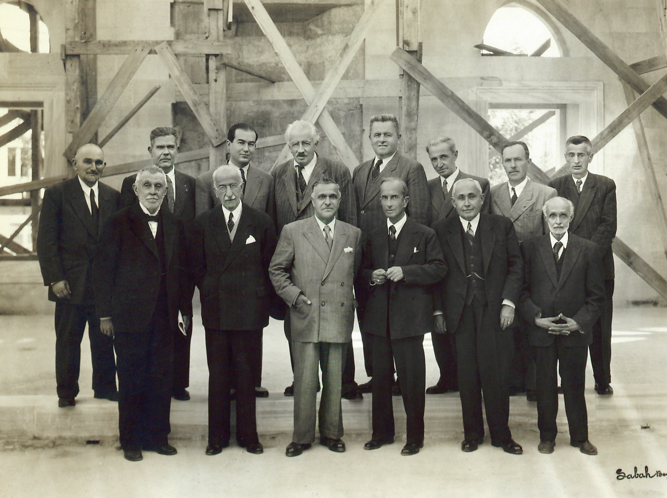 Aziz Ogan with Vasfi Egeli, the architect of the Şişli Mosque (front row, third from right), and others involved in the construction of the mosque, standing before the mihrab, second half of the 1940s